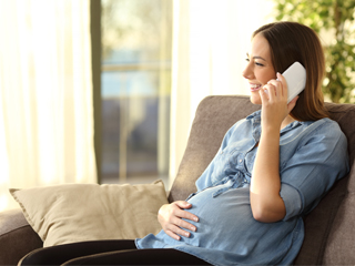Pregnant person on phone